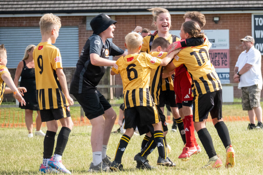Children celebrating scoring a goal at the the New Tupton Ivanhoe Summer Festival of Football