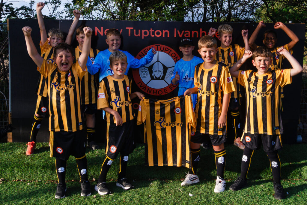 Tupton players holding up new kit with Fairplay sponsorship